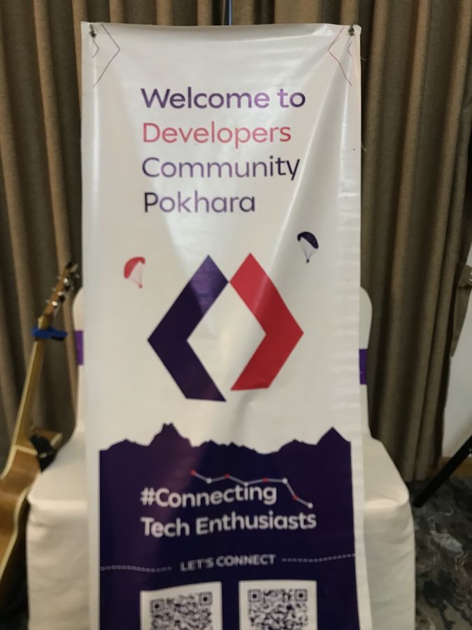 Welcome banner for Developers Community Pokhara at an indoor meetup